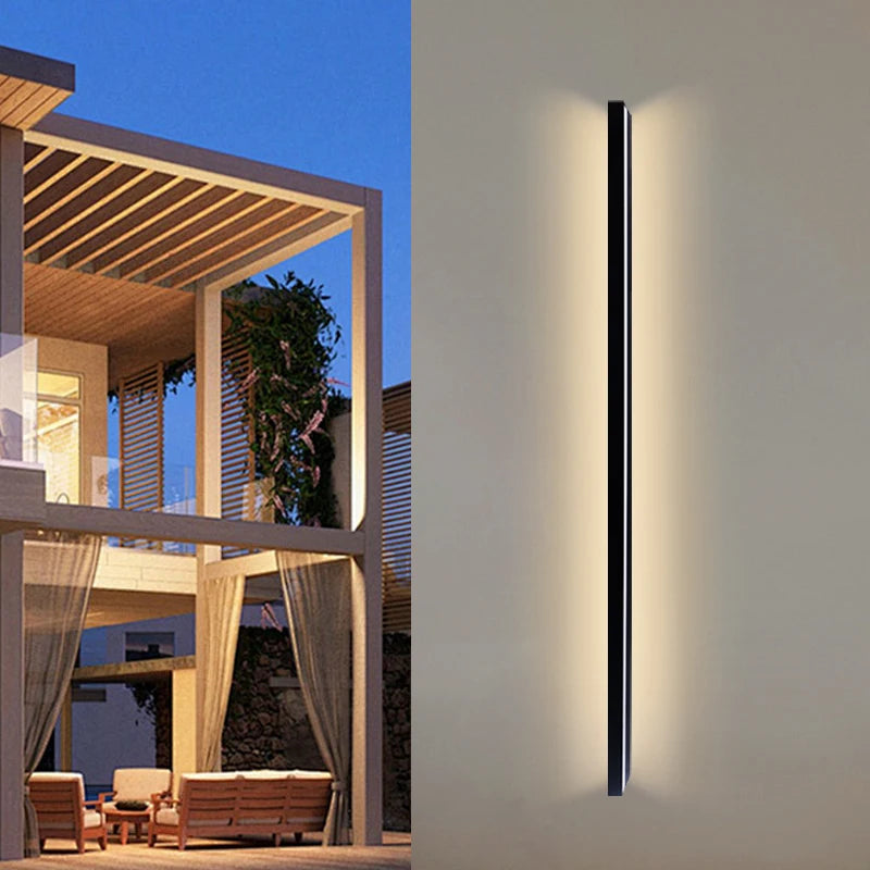 Vue nocturne de l'applique LED 145 cm illuminant une façade contemporaine
