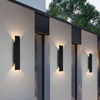 Applique aluminium blanche allumée sur mur extérieur, diffusion haut bas