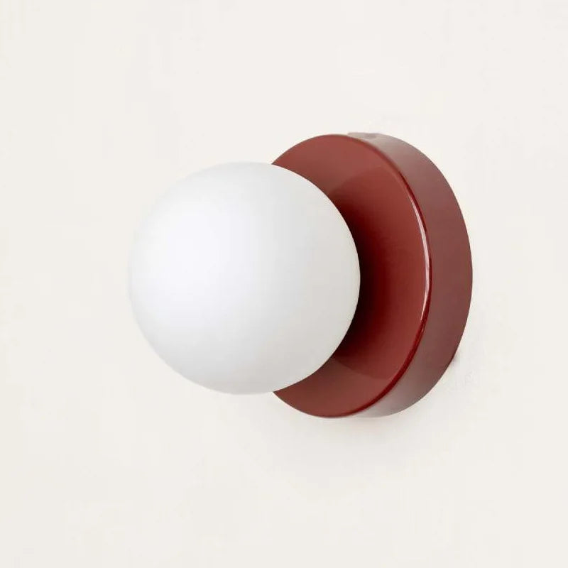 Applique macaron mini blanche 10 cm en lumière chaude au chevet