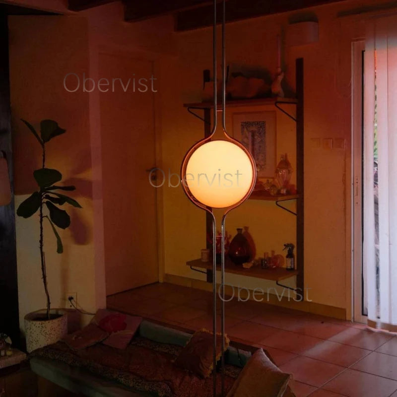 Lampadaire design boule acrylique sur pied chromé allumé, salon moderne