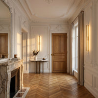 Applique Trait coloris doré, dans un appartement haussmannien, allumée